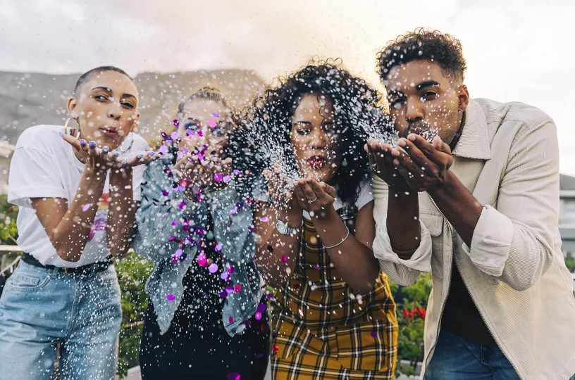 International expert, Pro is for you: a picture of diverse people blowing out glitter