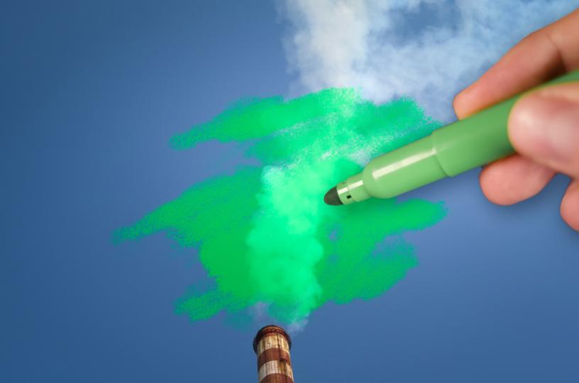 Ihminen värittää savupiipun harmaata savua vihreäksi. 