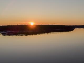 keskiyön aurinko järven yllä Sodankylässä