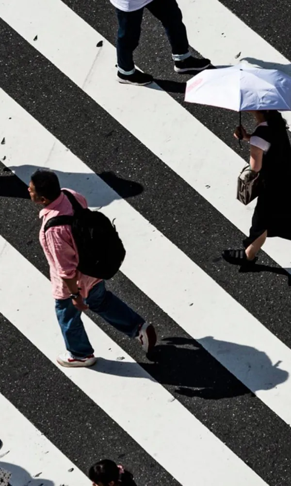 A story of working together: a picture of people crossing a crosswalk and walking in different directions
