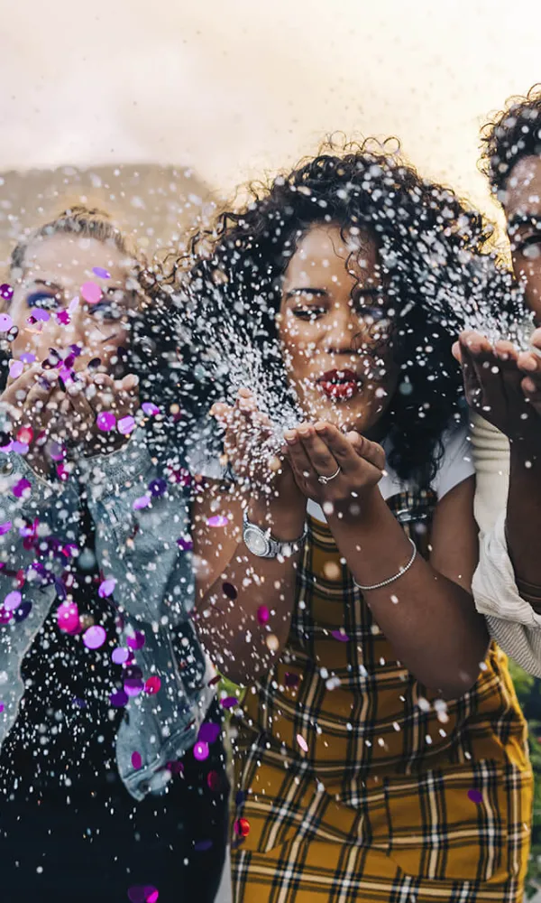 International expert, Pro is for you: a picture of diverse people blowing out glitter